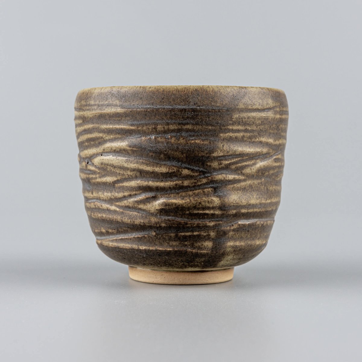 Rustic handmade ceramic mug set with engraved details, crafted for coffee, tea, and matcha in luxury dining settings.