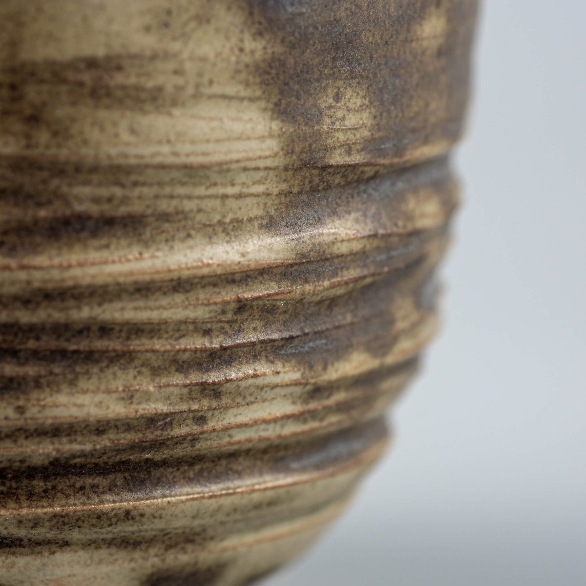 Luxury ceramic mug detail with natural stoneware texture and glaze variations, ideal for restaurants and interior design.
