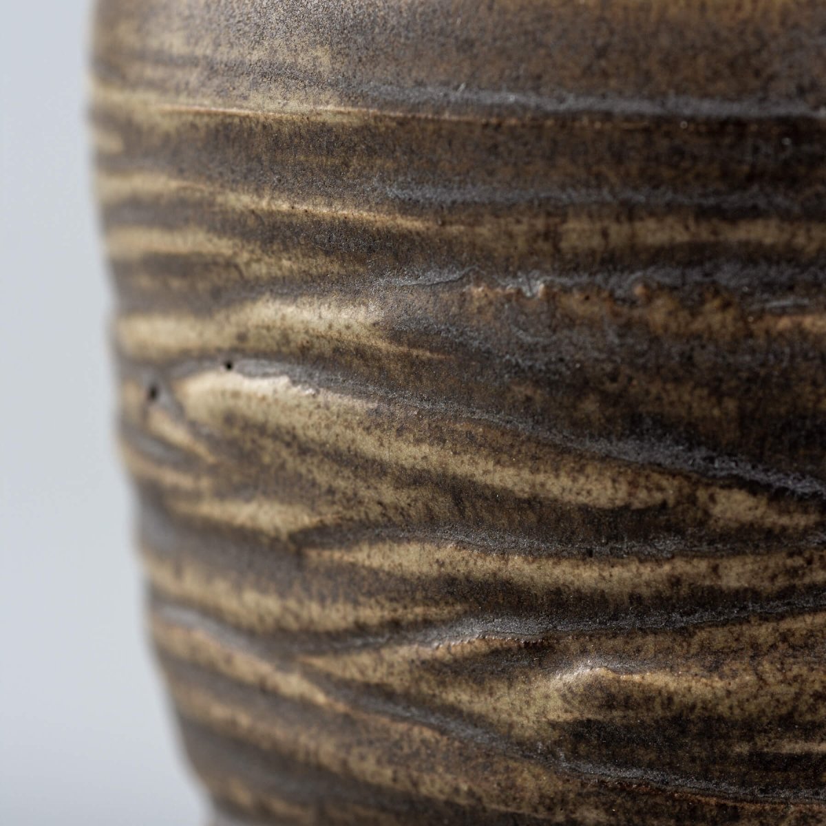 Detailed surface of handmade ceramic mug with rustic glaze, perfect for culinary presentation and fine dining rituals.