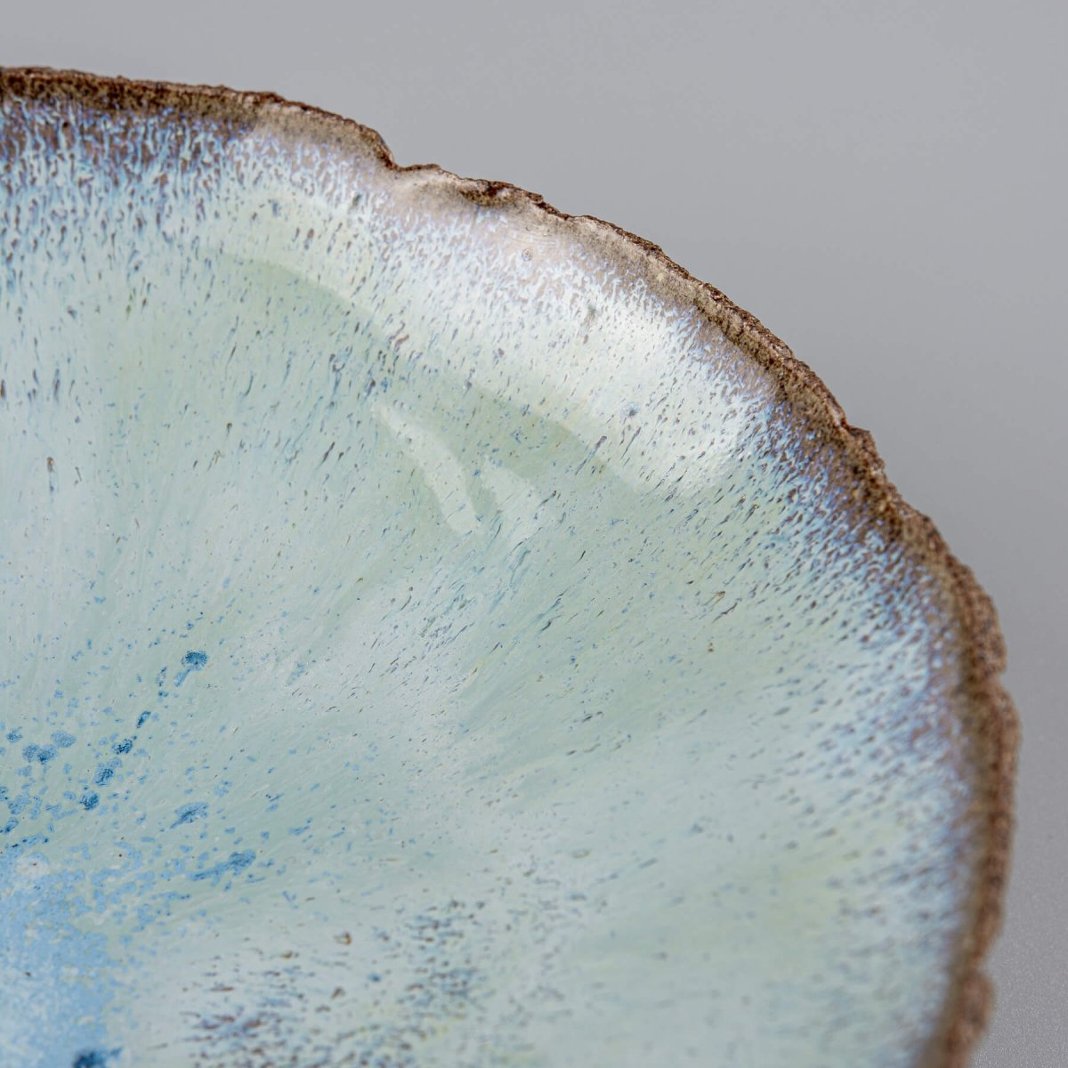 Angled view of bowl highlighting contrast between glaze and raw clay.