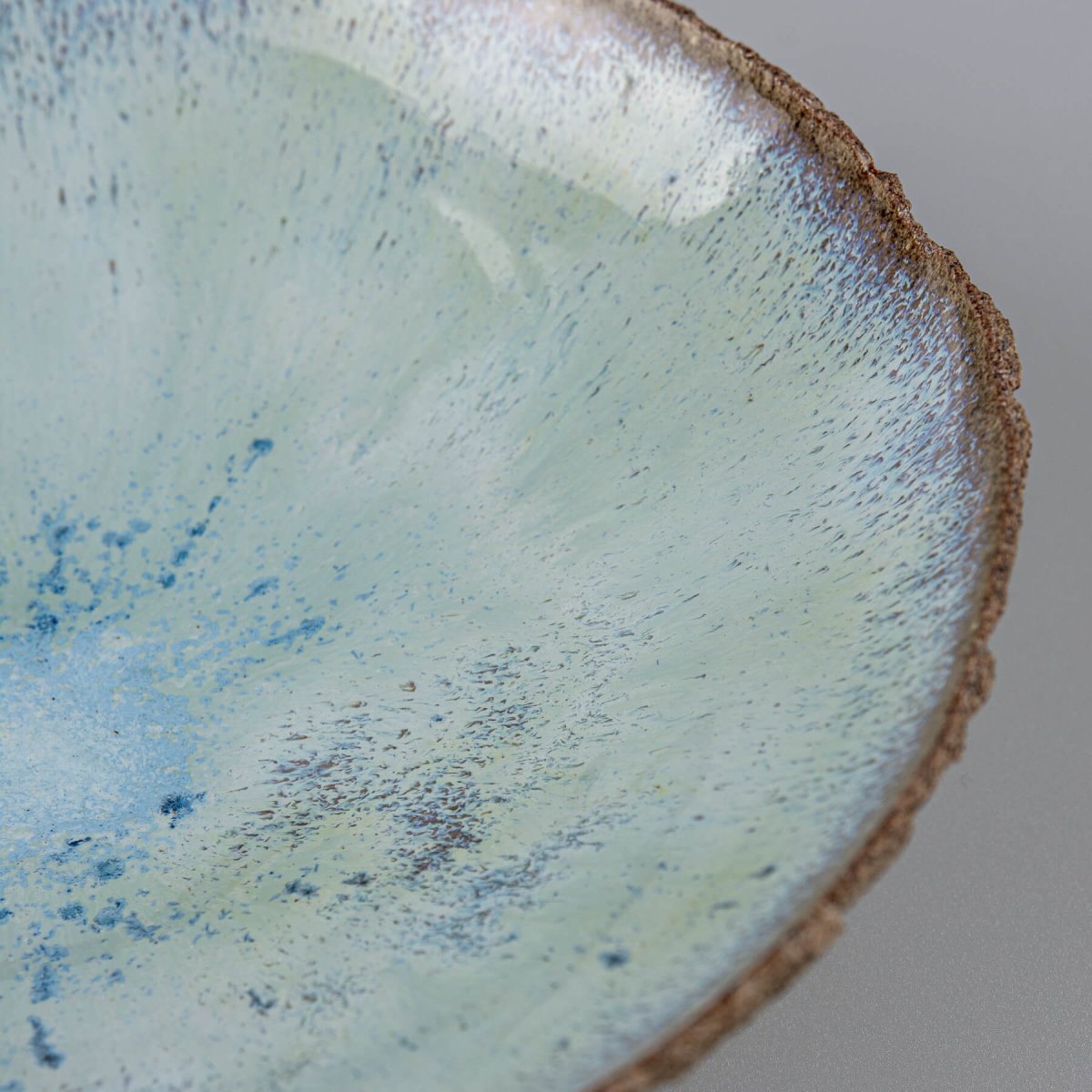 Interior rim detail with glossy glaze finish on artisan bowl.