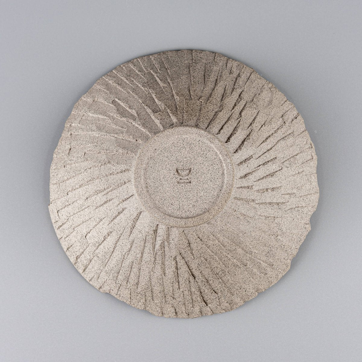 Bottom view of raw ceramic bowl showcasing potter’s wheel marks and collectible pottery appeal.