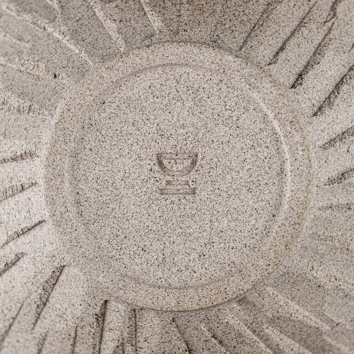 Bottom view of raw ceramic bowl showcasing potter’s wheel marks and collectible pottery appeal.