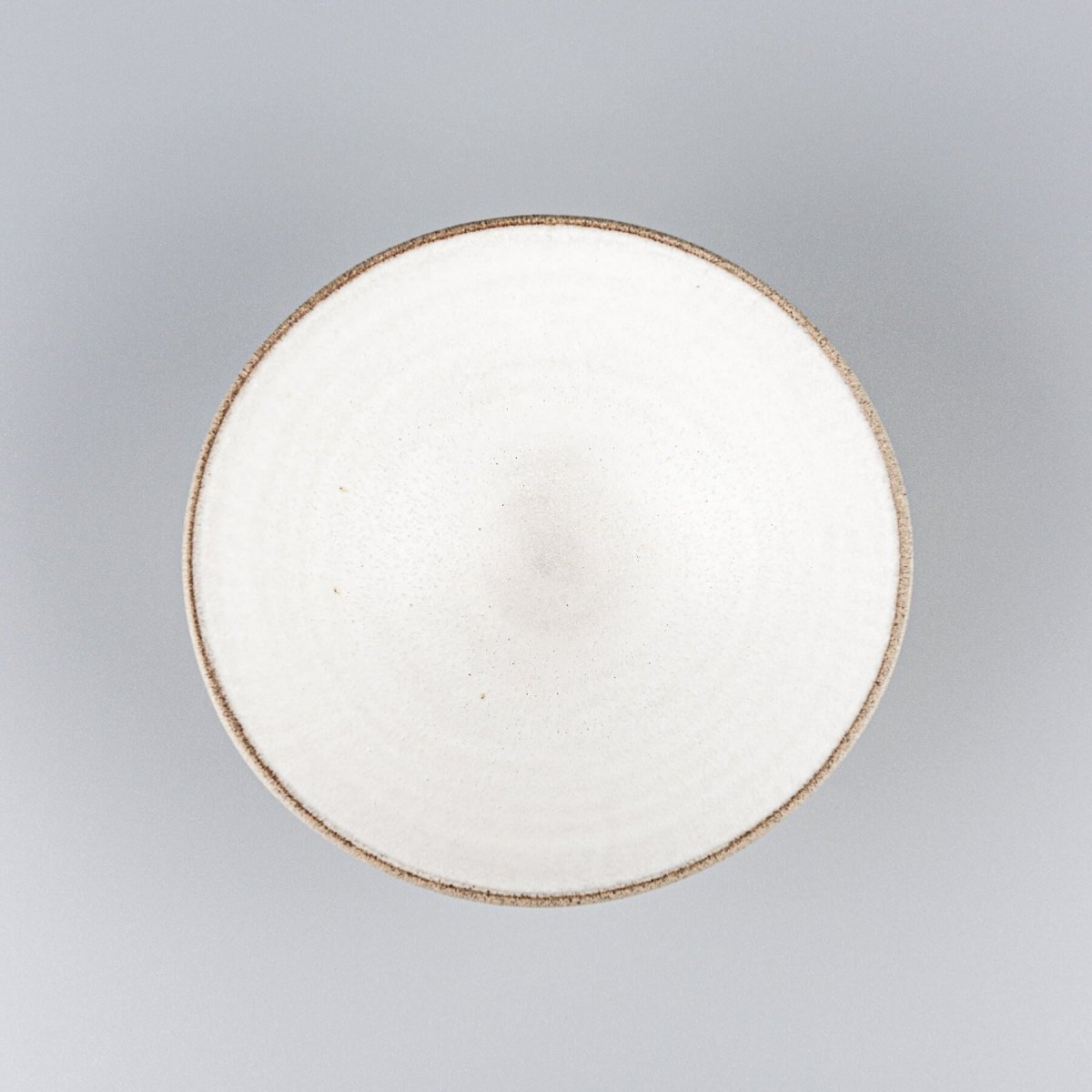 Top view of handmade ceramic bowl with white matte glaze ideal for fine dining presentations.