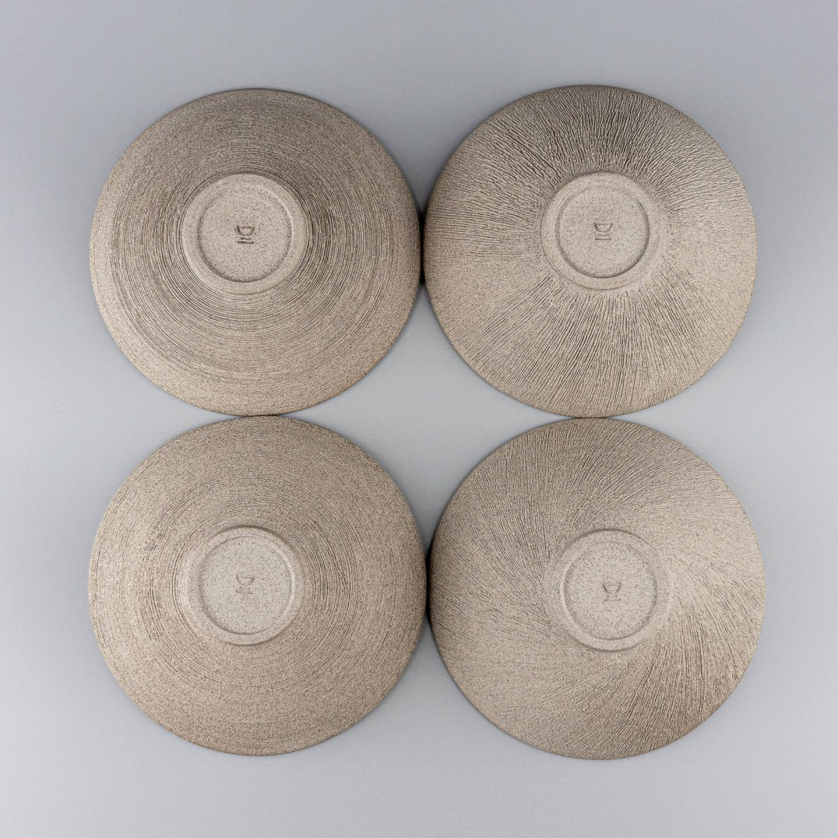 Set of four handcrafted bowls arranged in a group for kitchen or restaurant use.