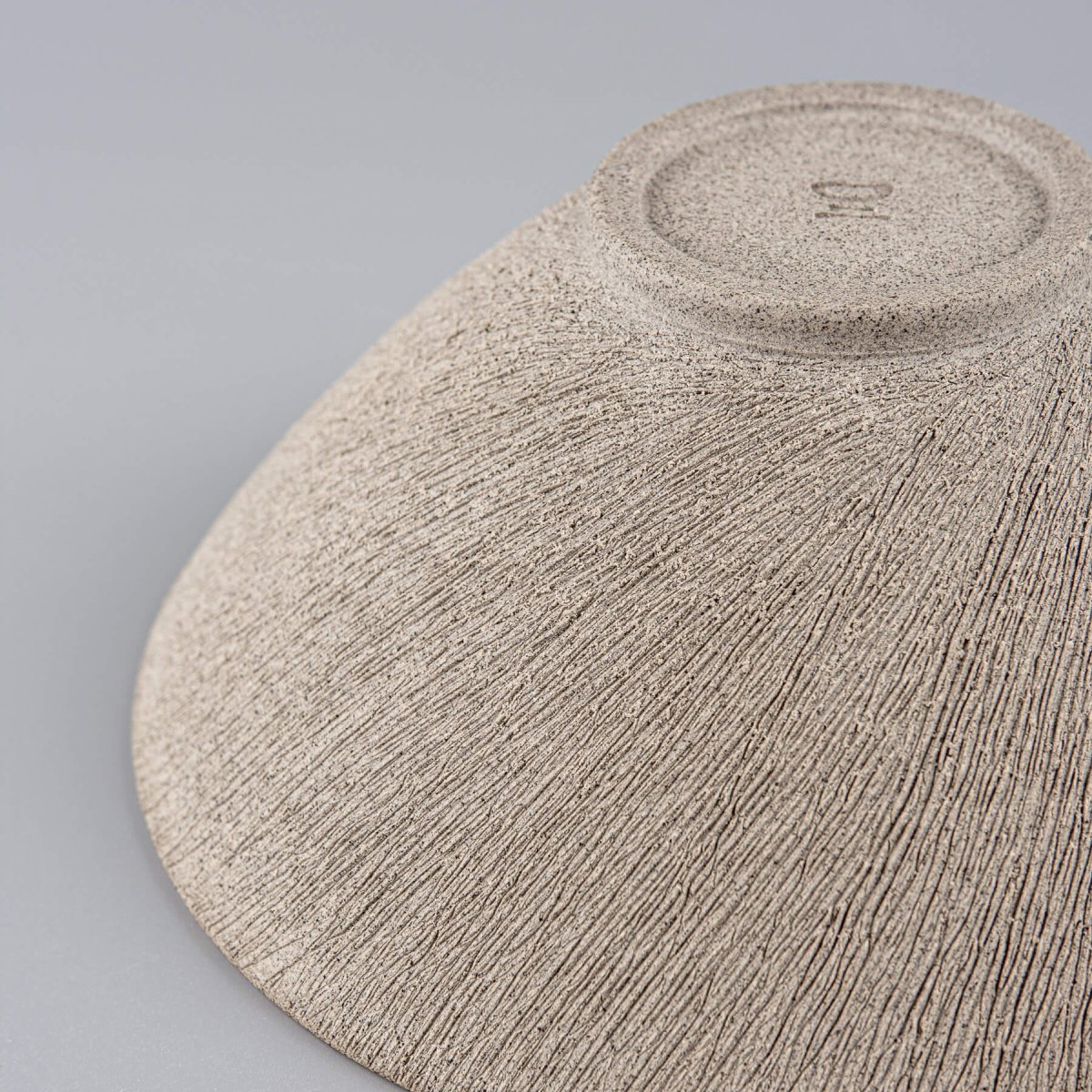 Angled view showing the fine craftsmanship and natural ceramic finish.
