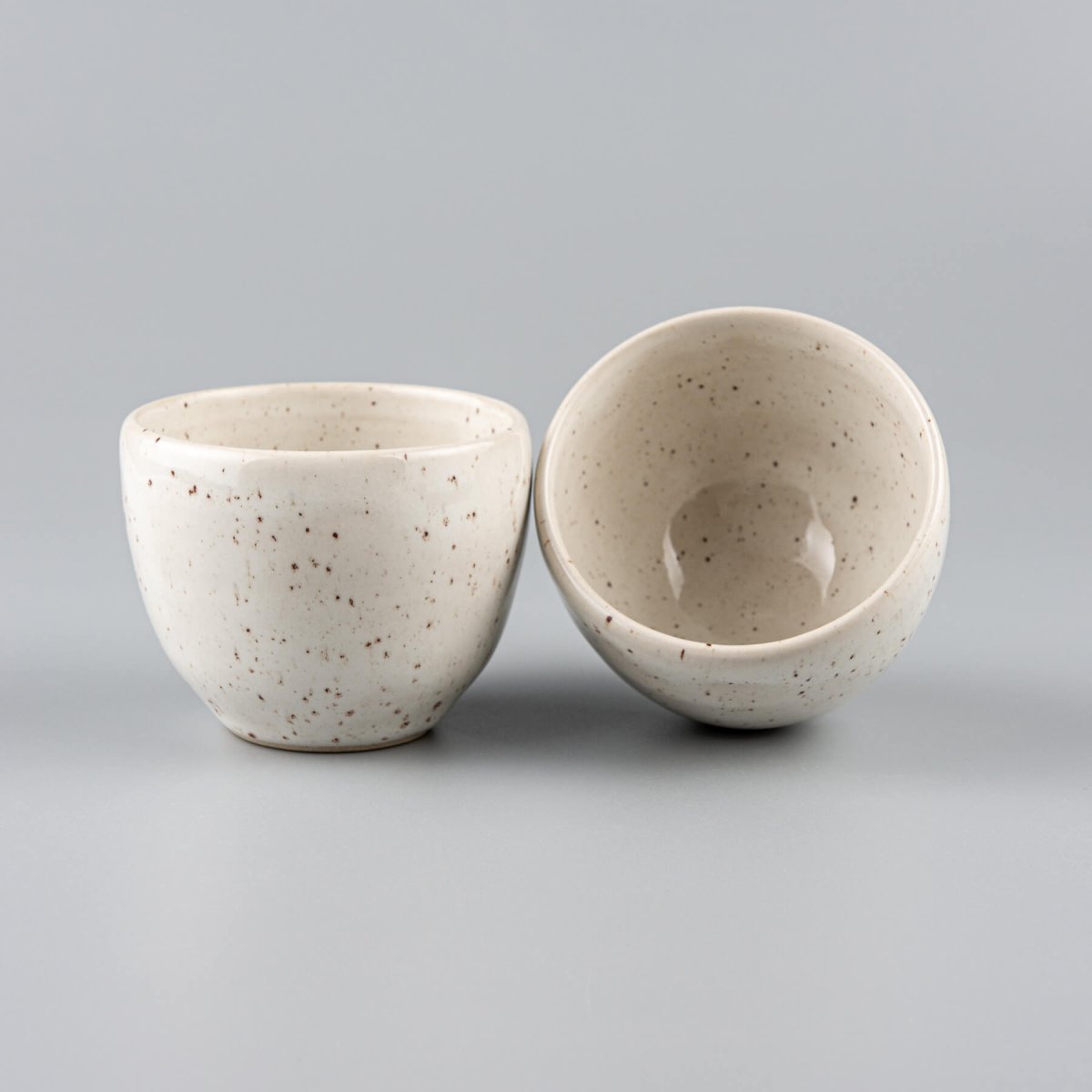 Side view of artisanal stoneware coffee cup in ivory glaze, suitable for restaurants and home kitchens.
