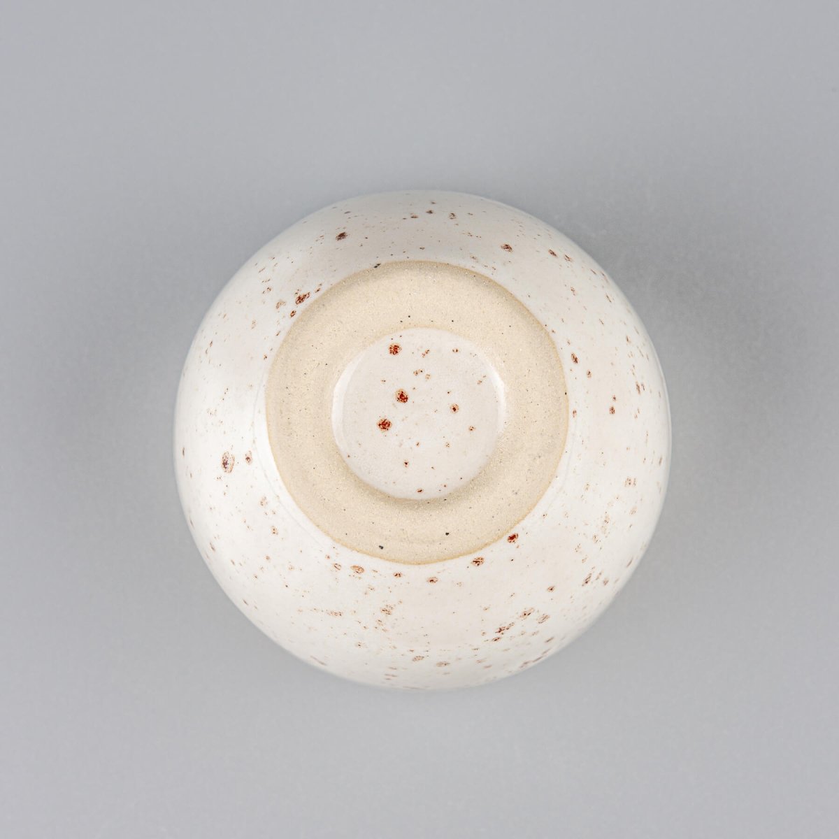 Bottom detail of artisanal stoneware coffee cup, collectible pottery for fine dining and interior design.