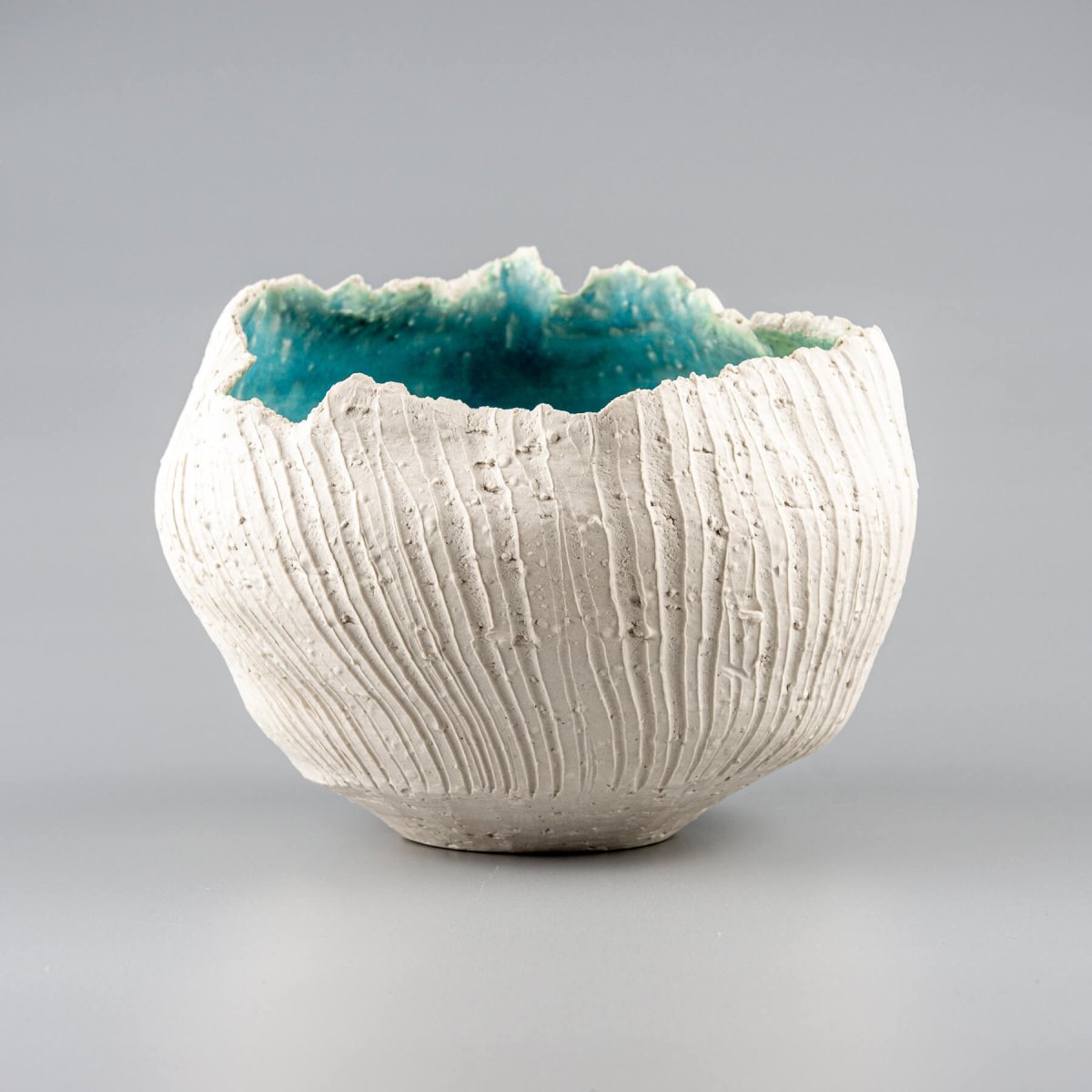 Handmade stoneware vase featuring a textured white exterior and a turquoise glazed interior, perfect for luxury home decor.