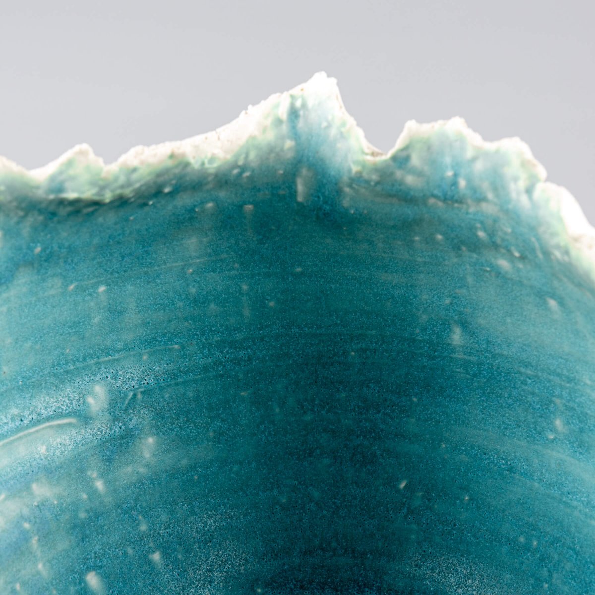 Elegant handmade stoneware vase with natural white exterior and striking turquoise interior for interior design.