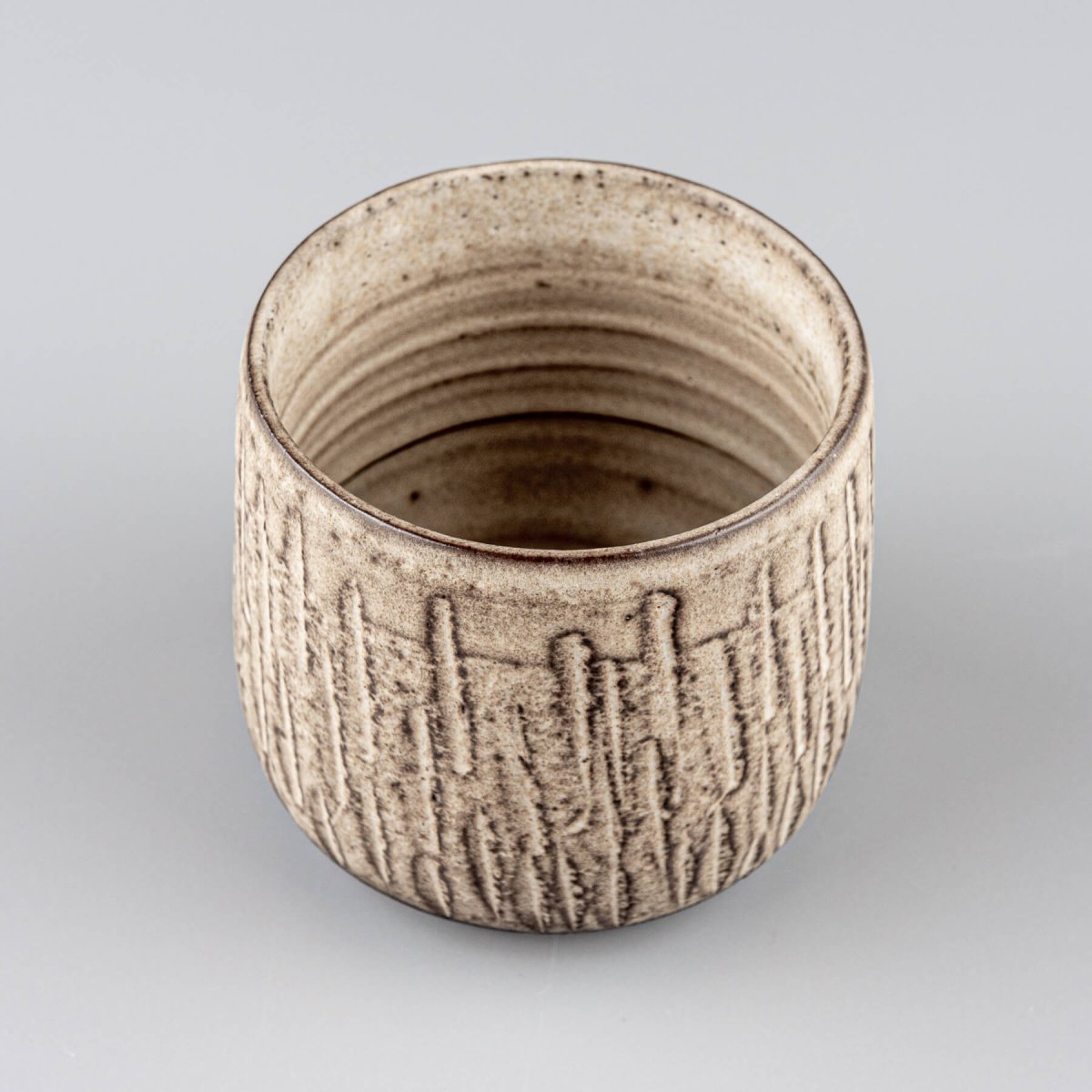 Top view of handcrafted ceramic mugs showing textured interior and artisan stoneware design.