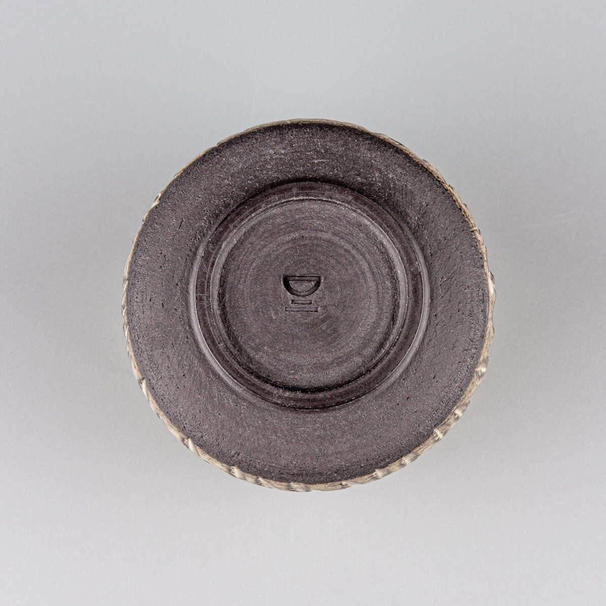 Bottom view of handcrafted ceramic mug showing potter’s wheel finish and stable base.