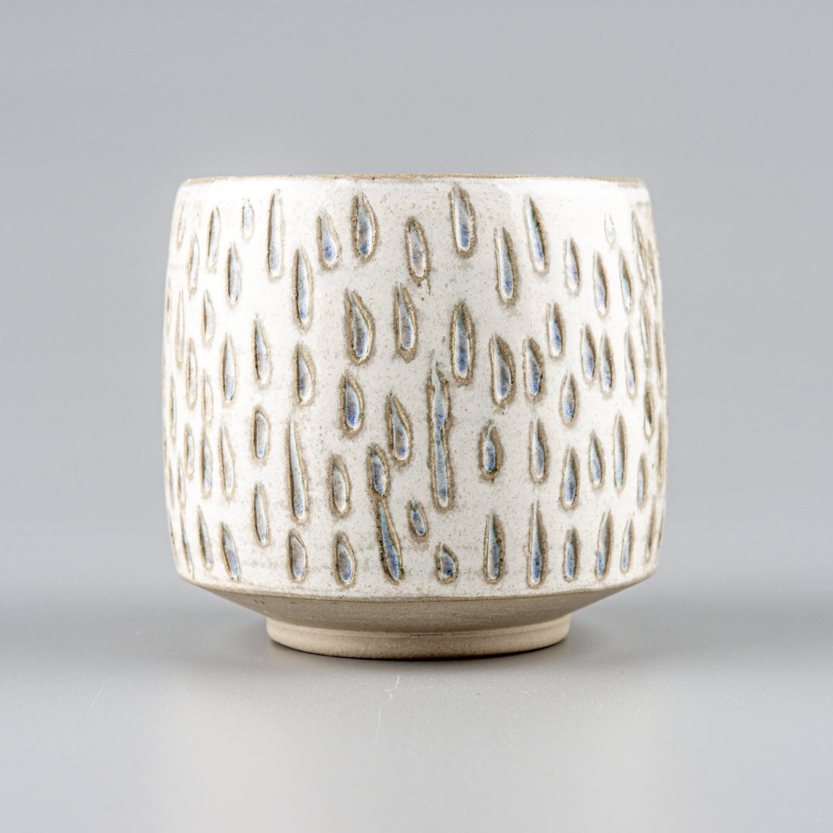 Handcrafted ceramic espresso cup with droplet pattern, perfect for coffee lovers and interior design accents.