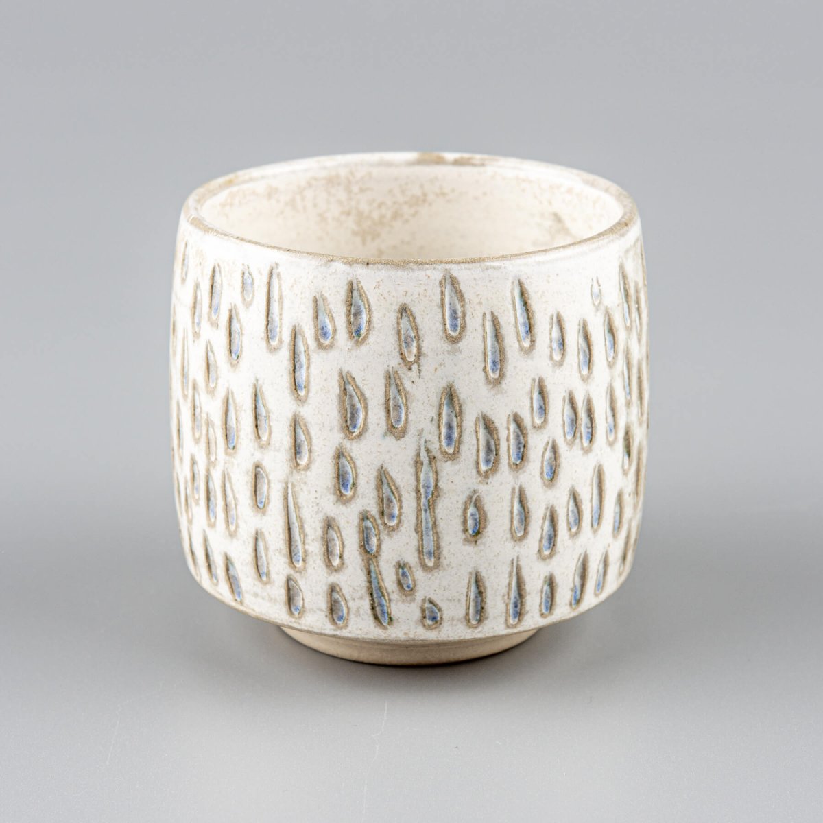 Artisan ceramic espresso cup with carved white clay texture for fine dining and boutique hotel settings.