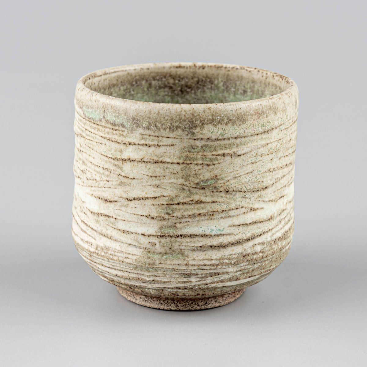 Artisan ceramic mug with layered glazes, ideal for fine dining and collectible pottery.