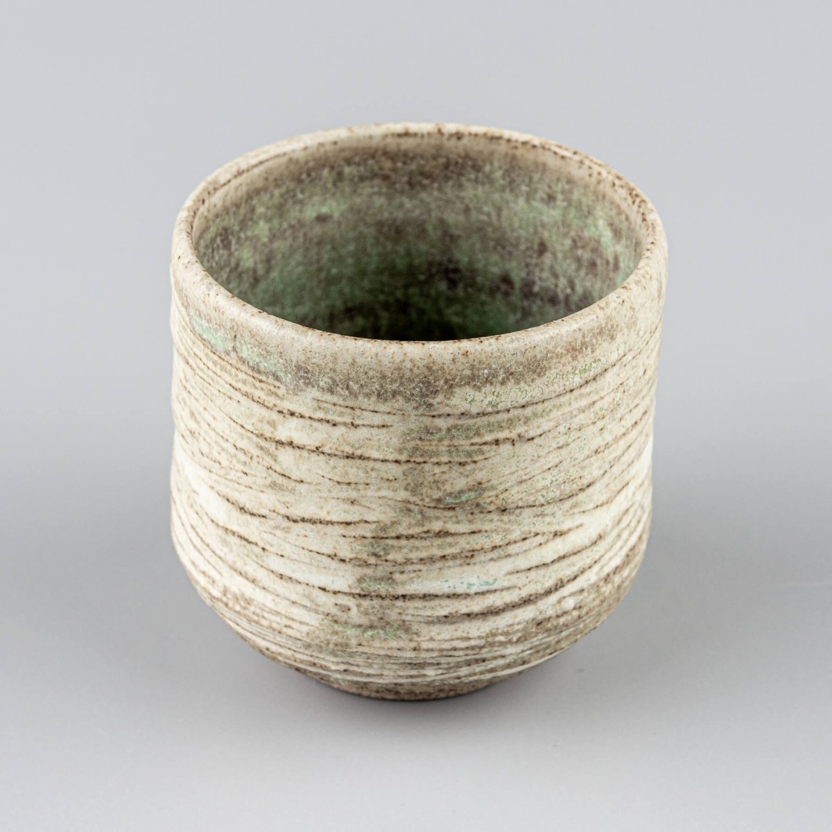 Rustic handmade mugs with earthy tones, perfect for boutique hotels and interior design.