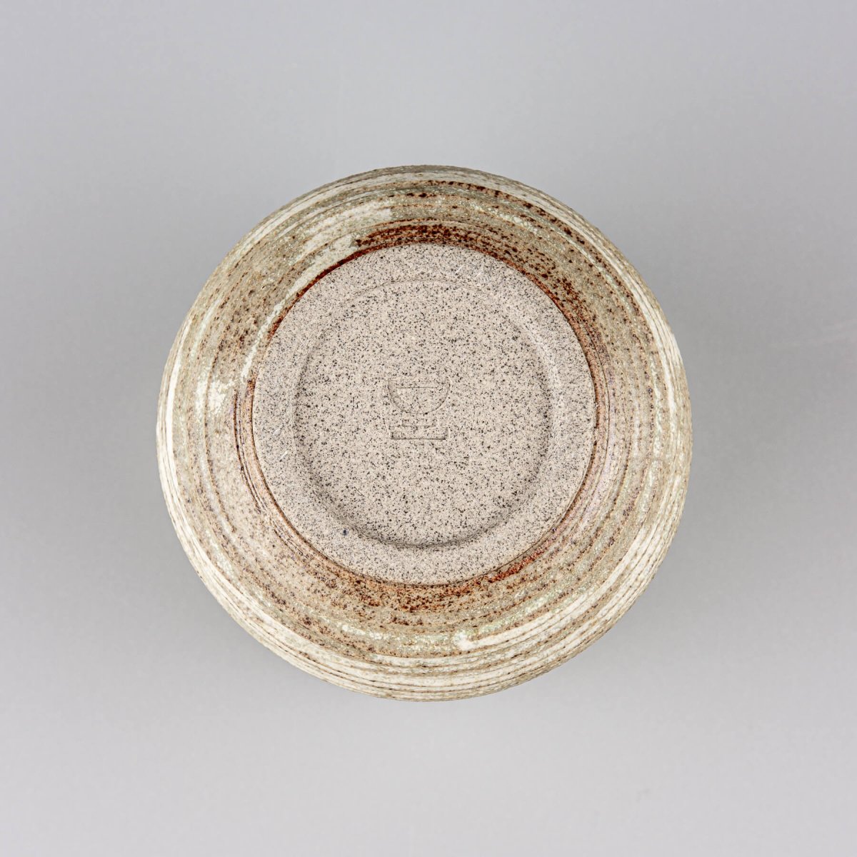 Base view of handmade ceramic mug, showcasing craftsmanship and durable stoneware design.