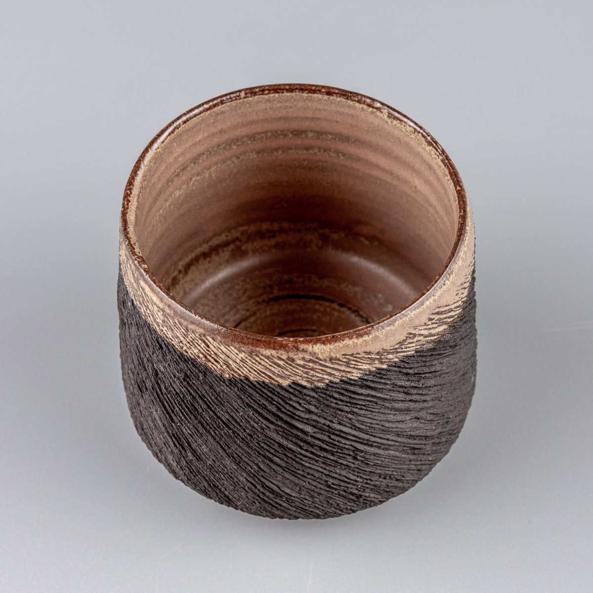 Top view of pottery mug with smooth glazed interior and textured exterior, ideal for kitchenware, and restaurants