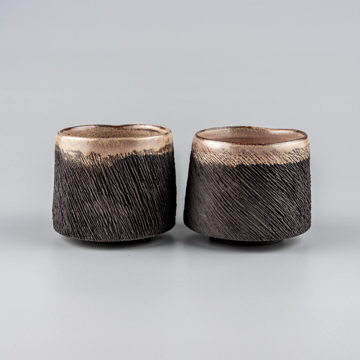Rustic pottery mugs set with semi-gloss glaze interior, ideal for boutique hotel or collectible pottery tableware.