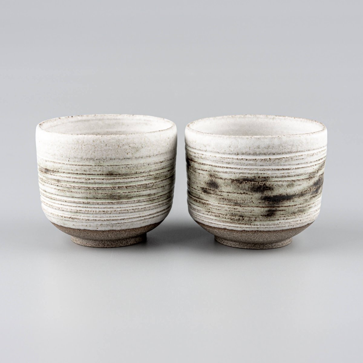 Stoneware mugs with textured exterior, perfect for coffee, tea, or fine dining presentation.