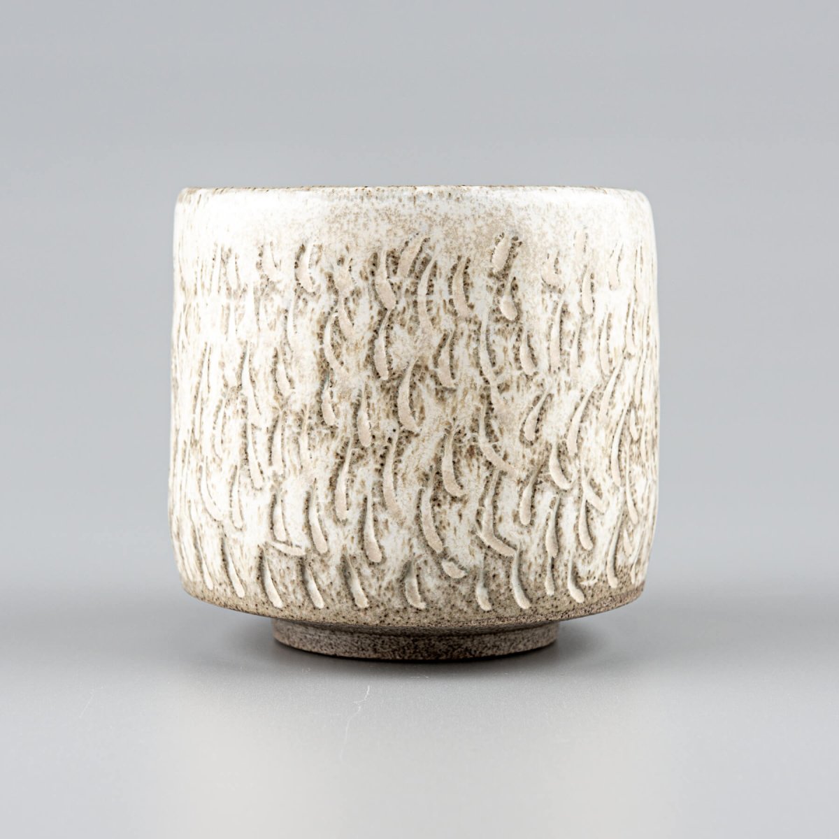 Unique ceramic espresso cup with hoof-like base, matte glaze, and artisan craftsmanship.