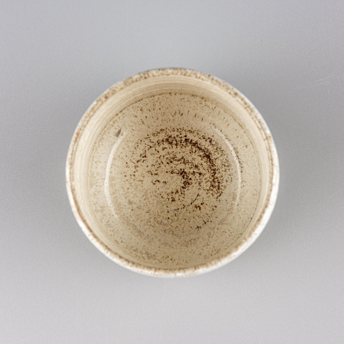 Top view of handmade ceramic espresso cup with natural matte glaze and artisan pottery finish.