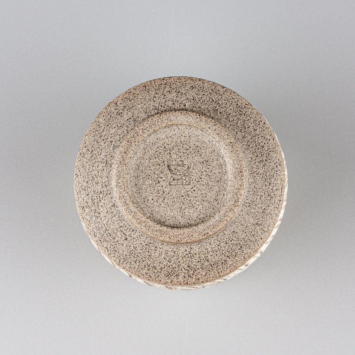 Base of artisanal ceramic espresso cup showcasing collectible pottery craftsmanship.