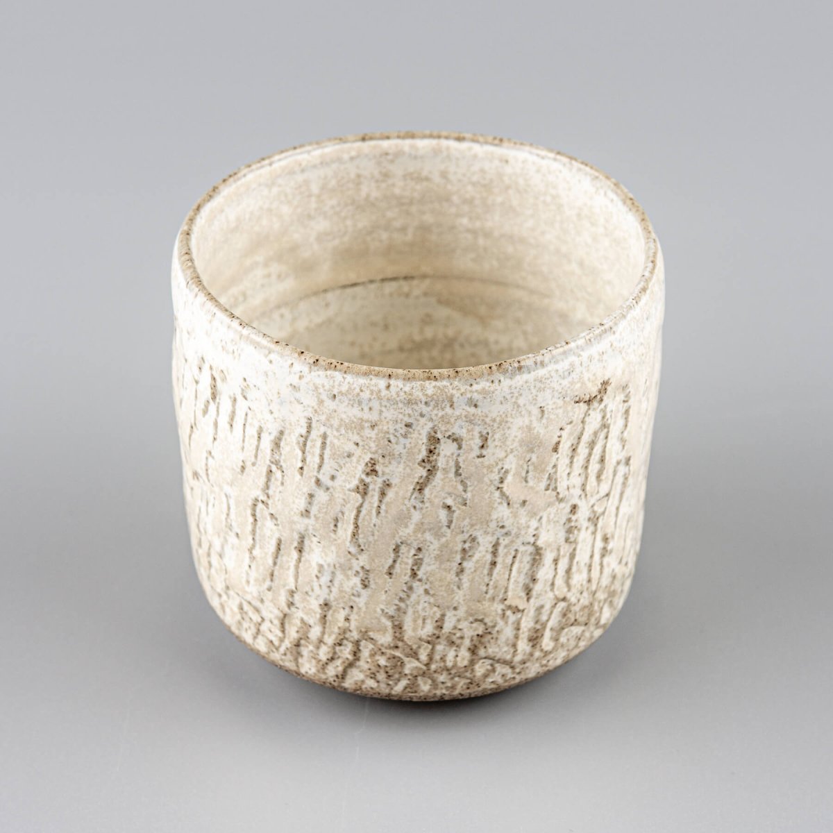 Espresso cup handmade from stoneware clay with fine carved details and matte finish.