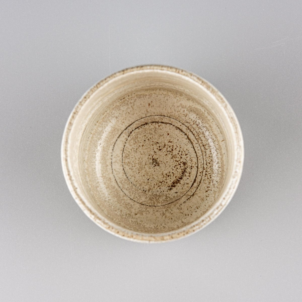 Top view of a ceramic espresso cup with a minimalist, handmade design for restaurants and homes.