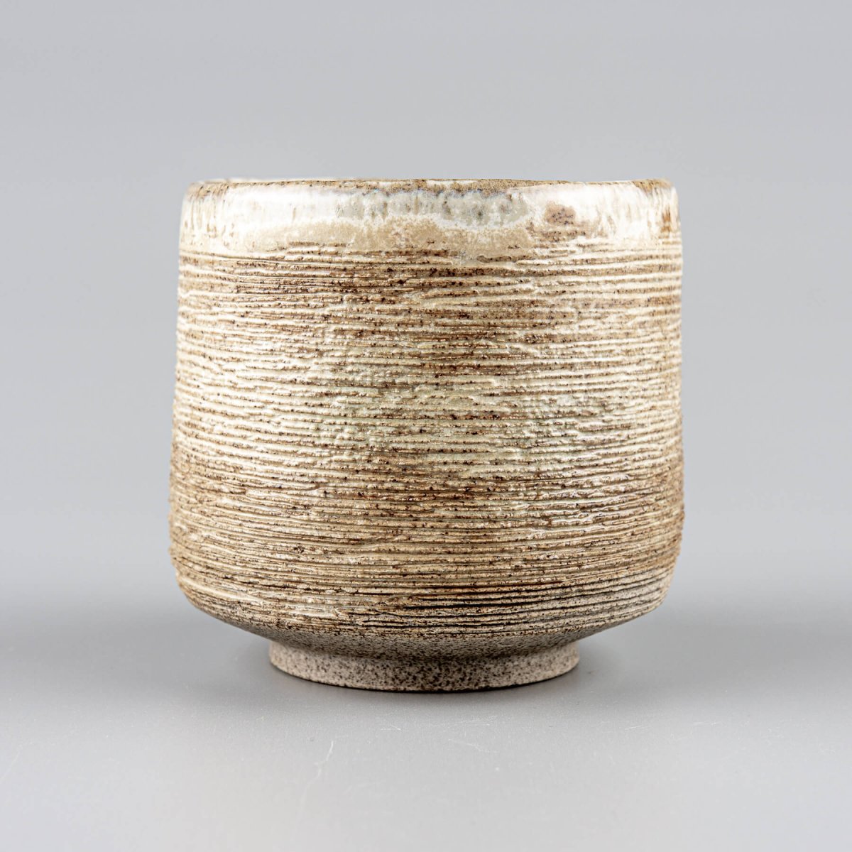 Handmade ceramic mugs with rustic carving and matte glaze, perfect for tea, coffee, or matcha rituals.