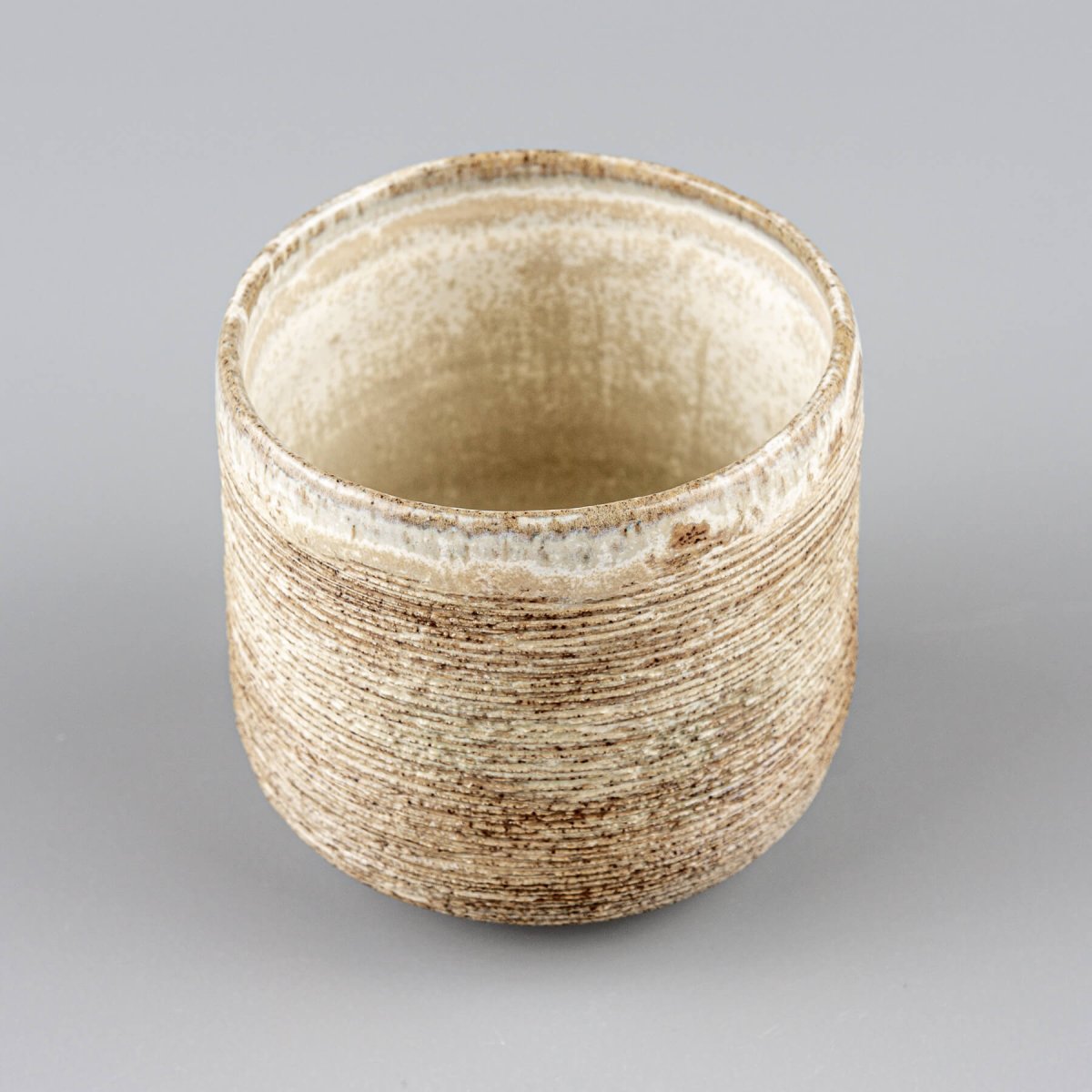 Handmade ceramic mugs with earthy tones and matte glaze, perfect for homes, hotels, and restaurants.