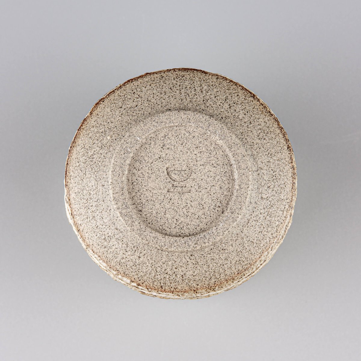 Base of stoneware pottery mug, showcasing limited edition handmade tableware.