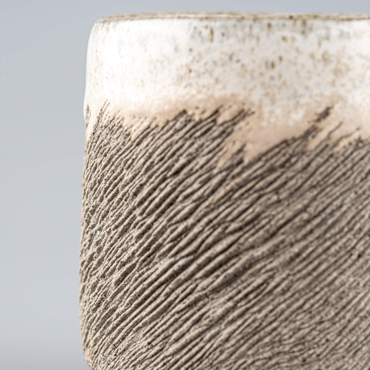 Handmade pottery coffee cup with rustic carved lines and white glaze, ideal for a housewarming gift or a wedding gift idea.