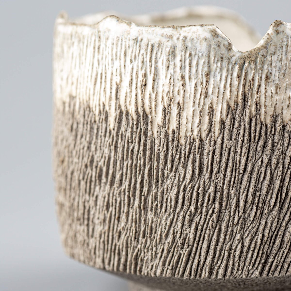 Close-up of textured stoneware coffee cup exterior for interior design and collectible pottery.
