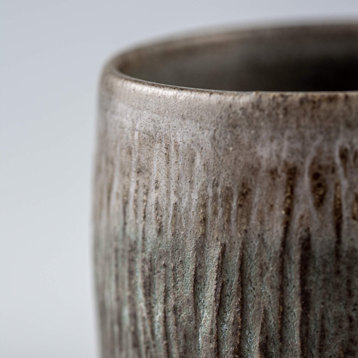 Artisanal stoneware coffee cups with carved details, perfect as a wedding gift or handmade collectible décor.
