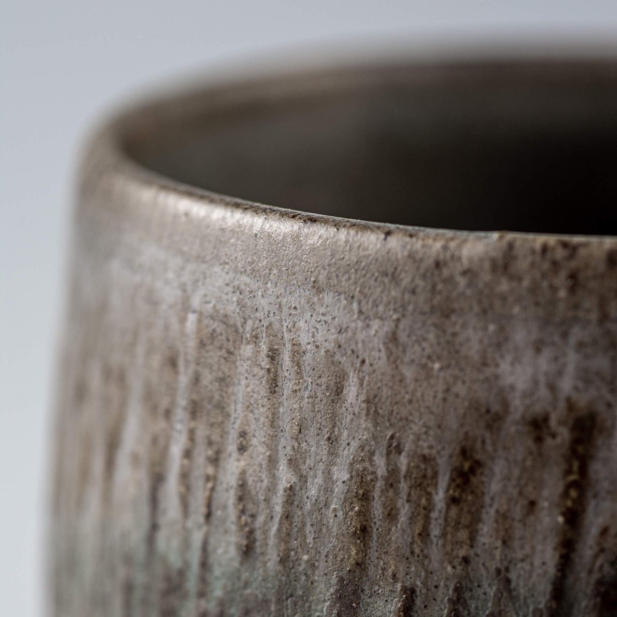Elegant handmade coffee cups from dark clay with carved design, versatile for restaurants, décor, or gifting.