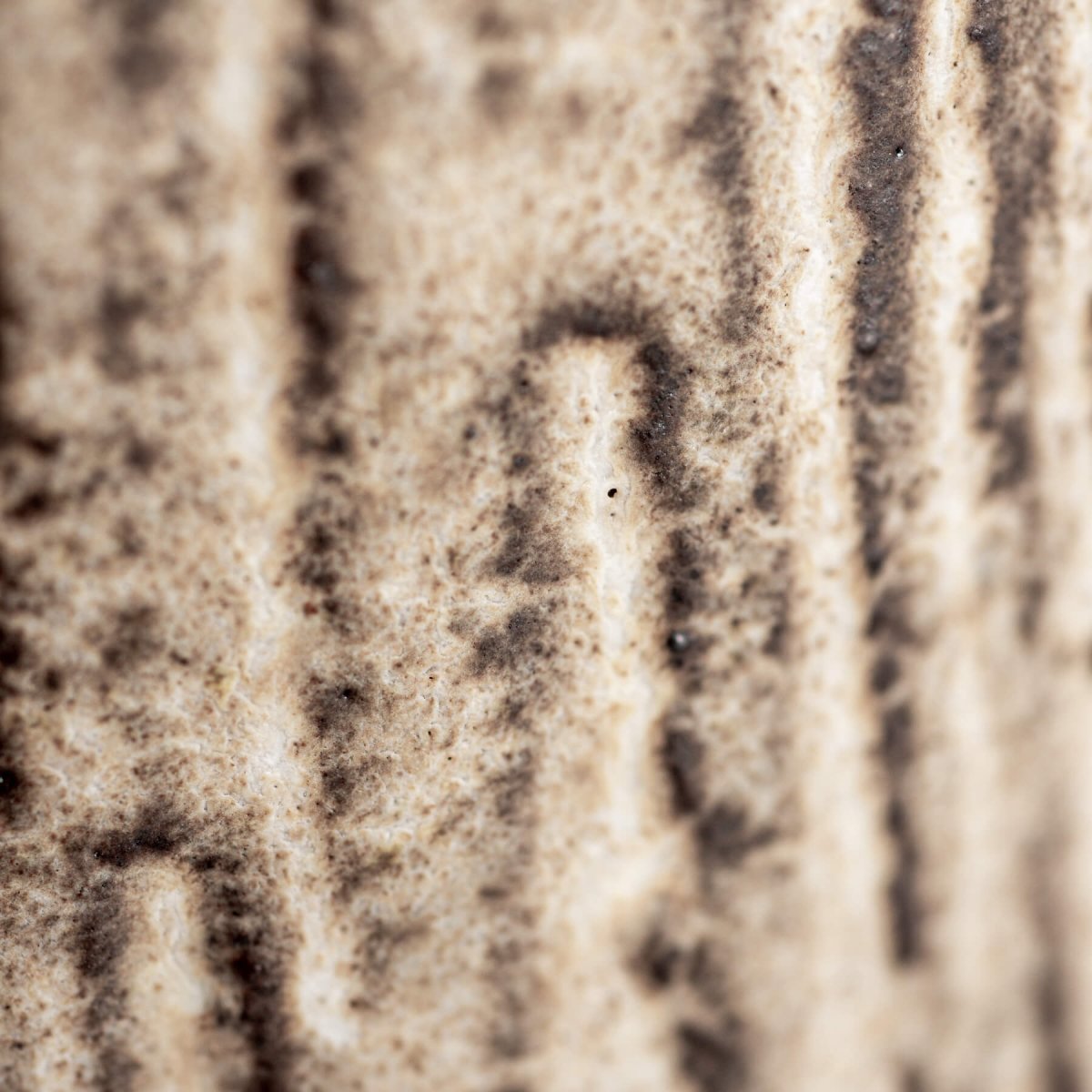 Vertical carved pattern detail on handcrafted ceramic mug with artisanal stoneware finish.