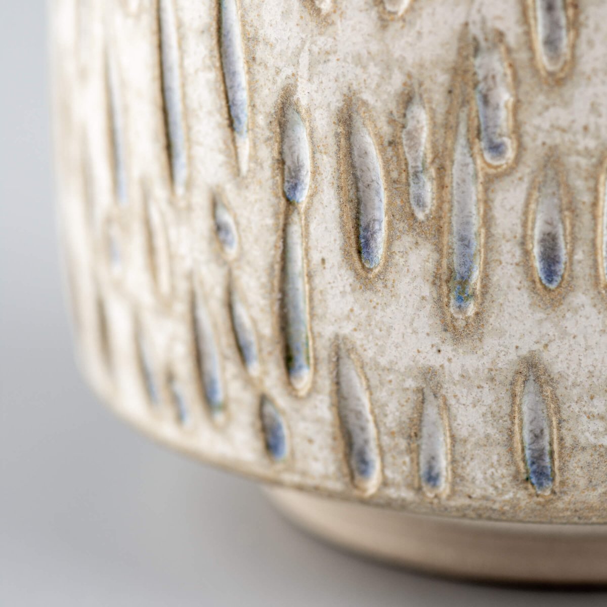 Close-up of textured ceramic espresso cup with artisanal details for restaurants and home decor.