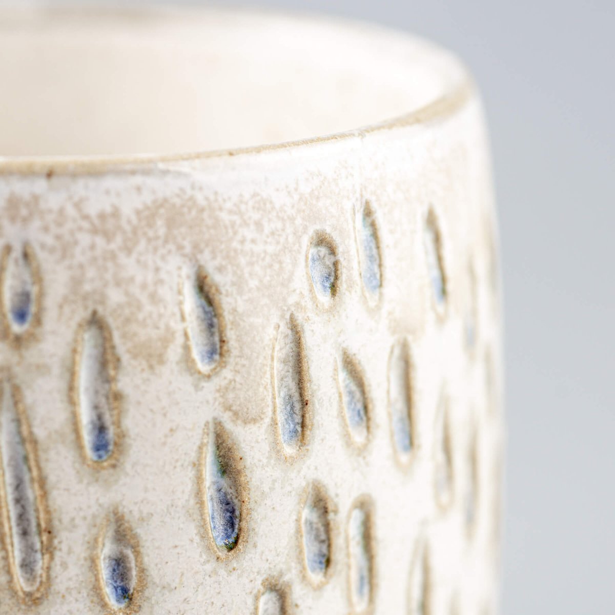 Artisan ceramic espresso cup highlighting unique handmade texture and interior design value.