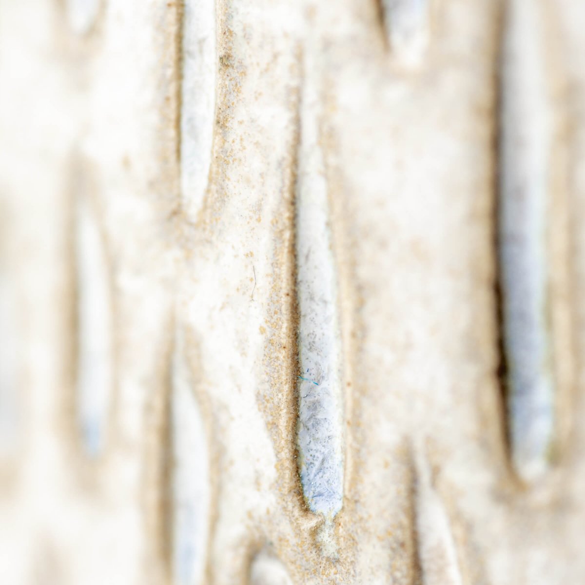 Close-up of artisanal ceramic espresso cup surface showing unique droplet texture for collectible pottery.