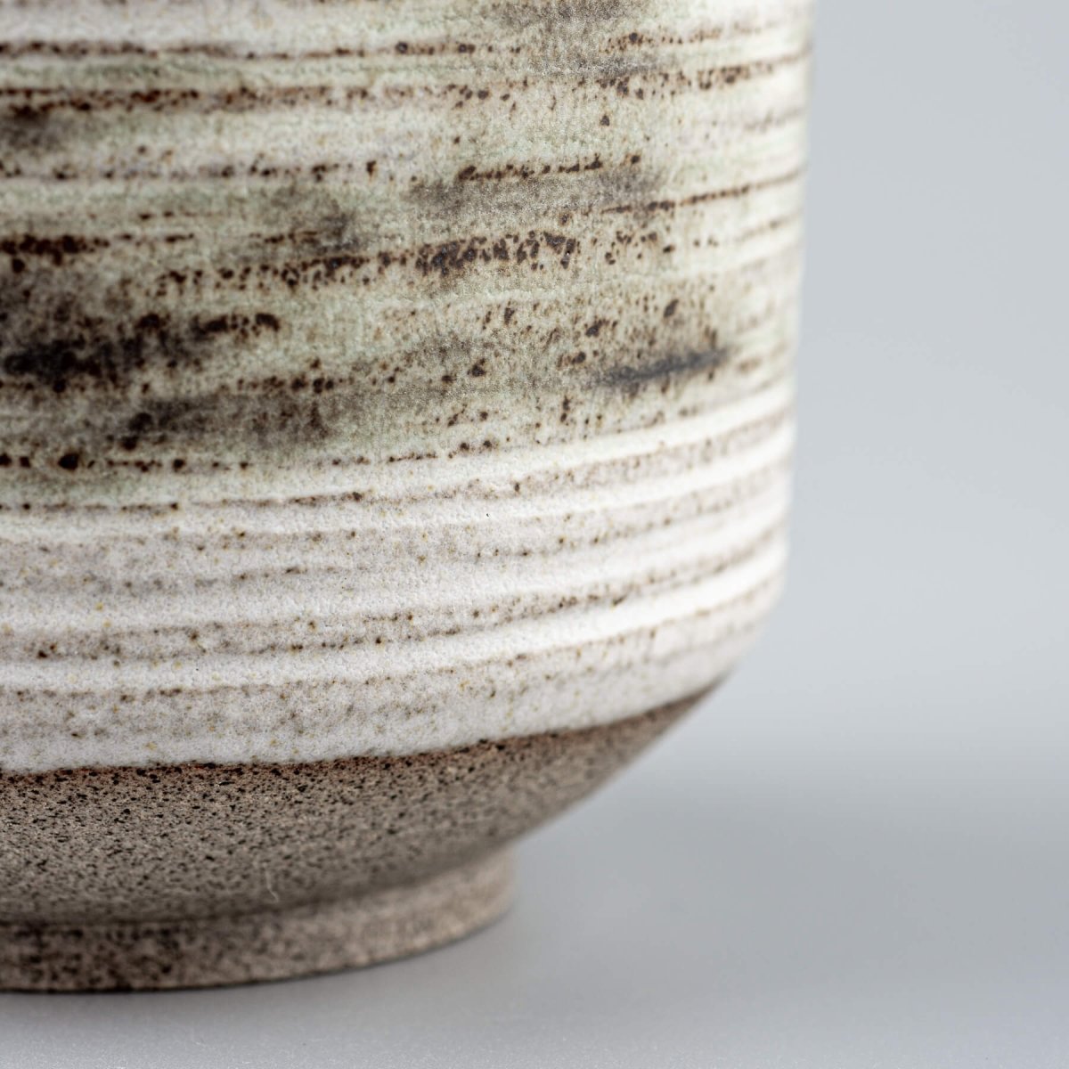 Rustic pottery mugs with white glaze, designed for culinary presentation and gifting.