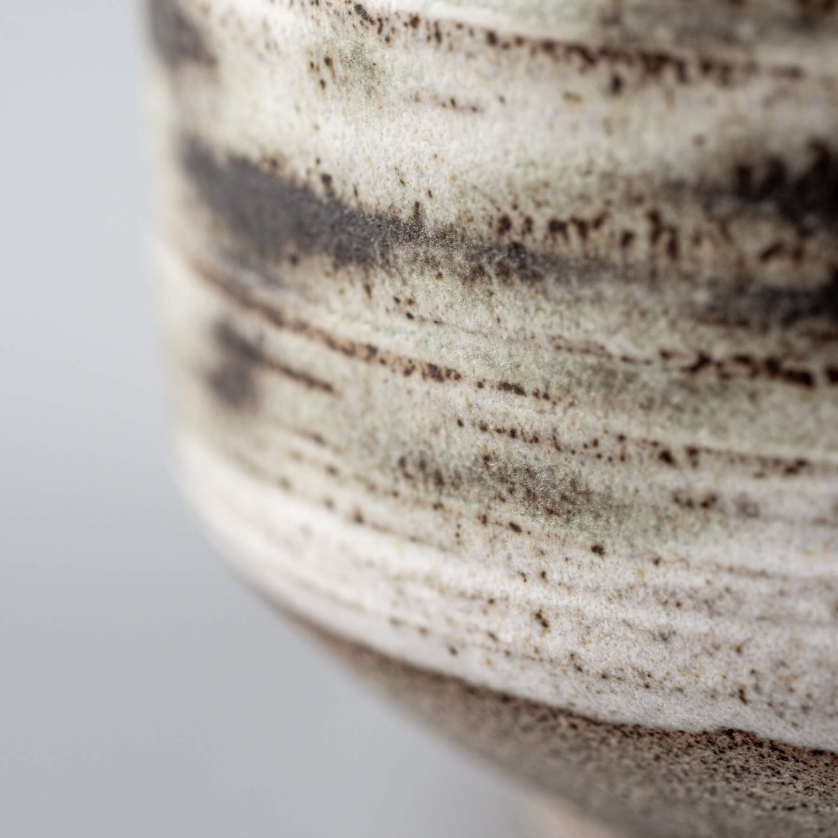 Contemporary pottery mugs with artistic carved design and matte finish.