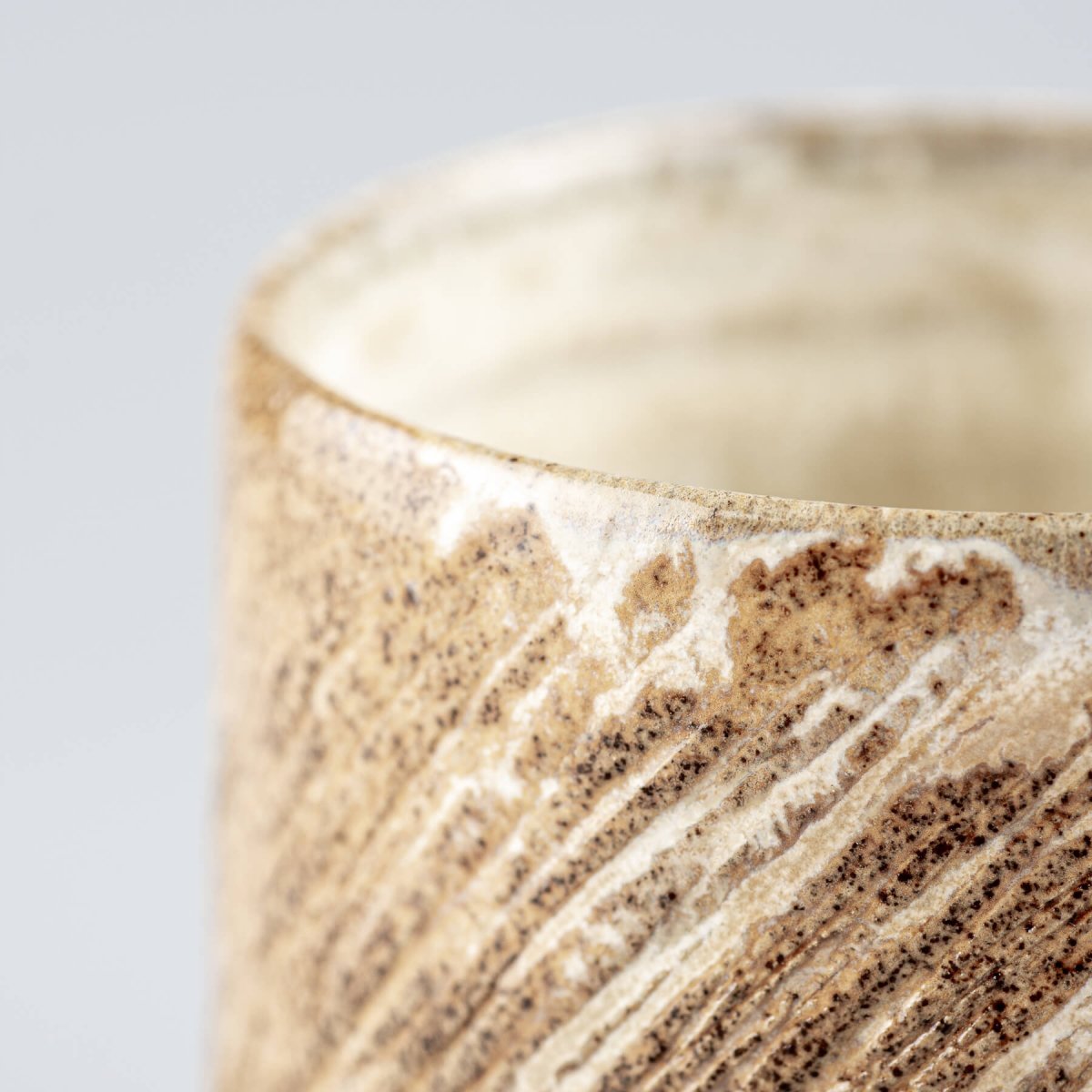 Rustic handmade ceramic mugs with textured carving, collectible pottery for private collectors.