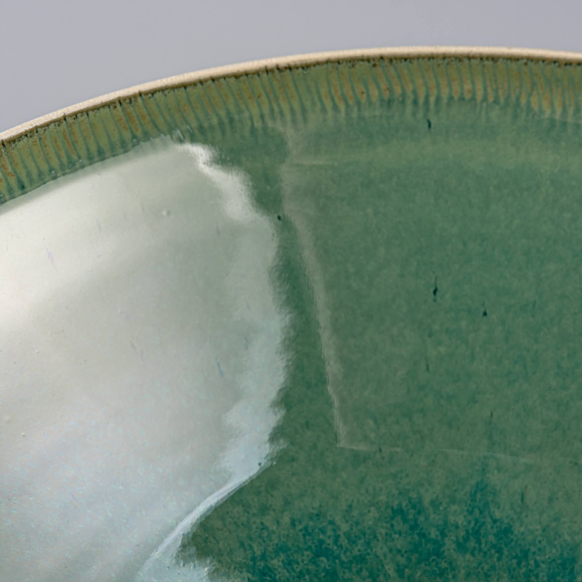 Interior close-up of bowl showing vibrant green glossy finish and smooth texture.
