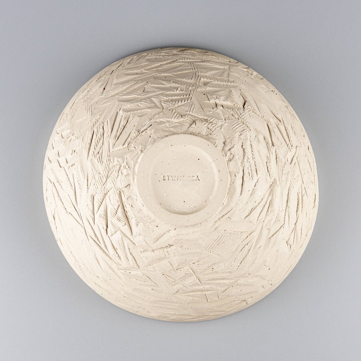 Top-down view of ceramic serving bowl highlighting central spiral and color depth of glaze.