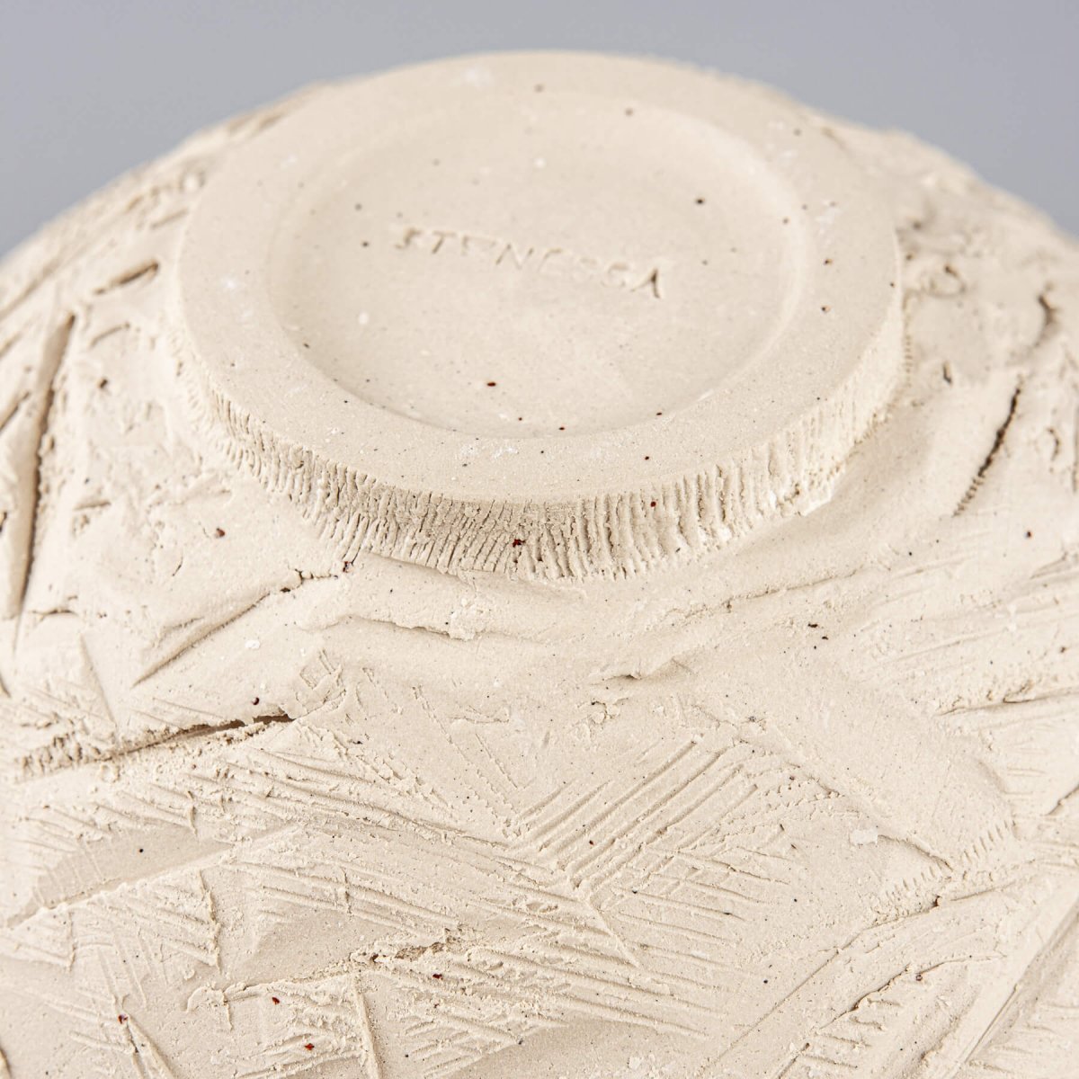 Bottom side view showing foot ring and unglazed ceramic texture on handcrafted bowl.