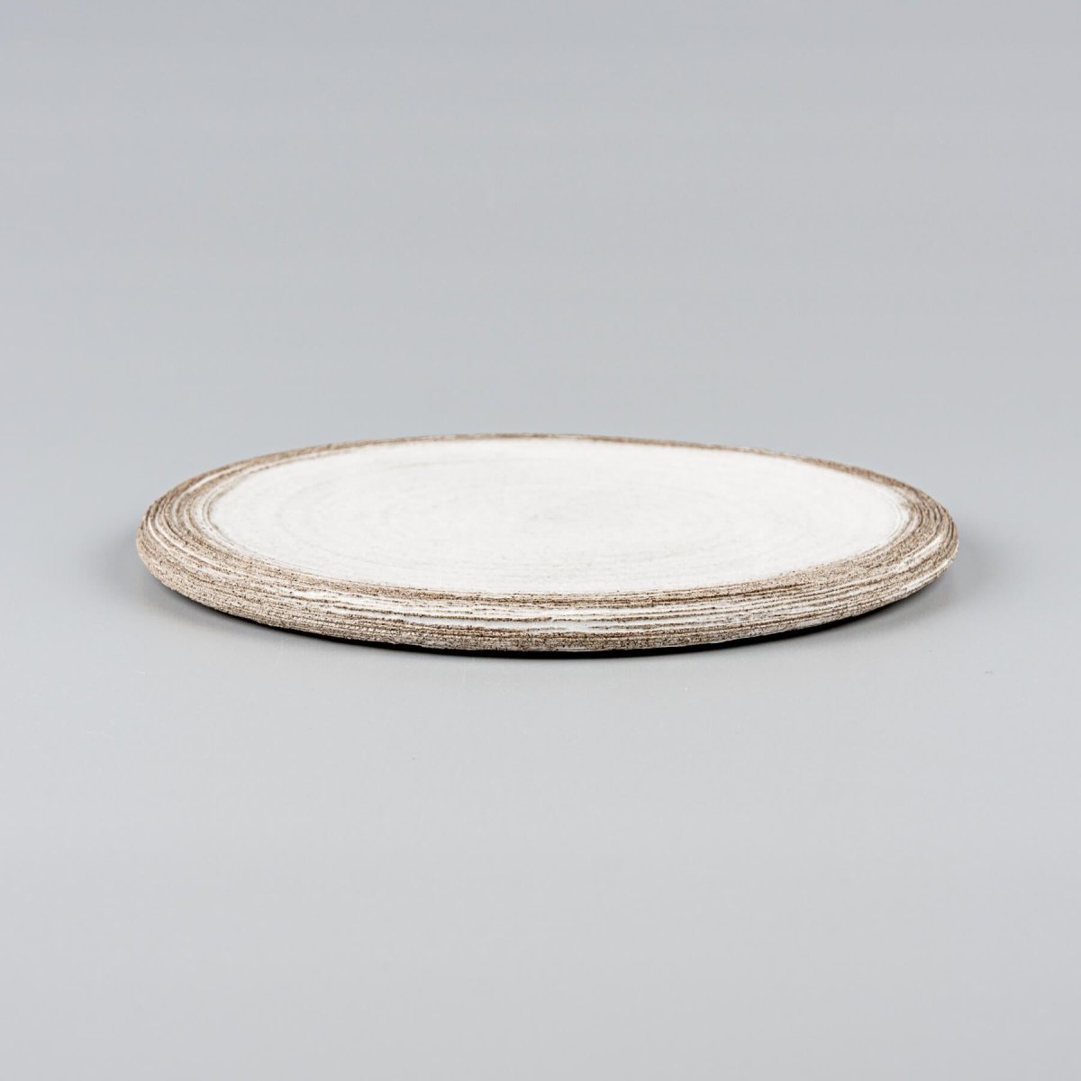 Stacked handmade ceramic plates with minimalist flat design for premium restaurants.