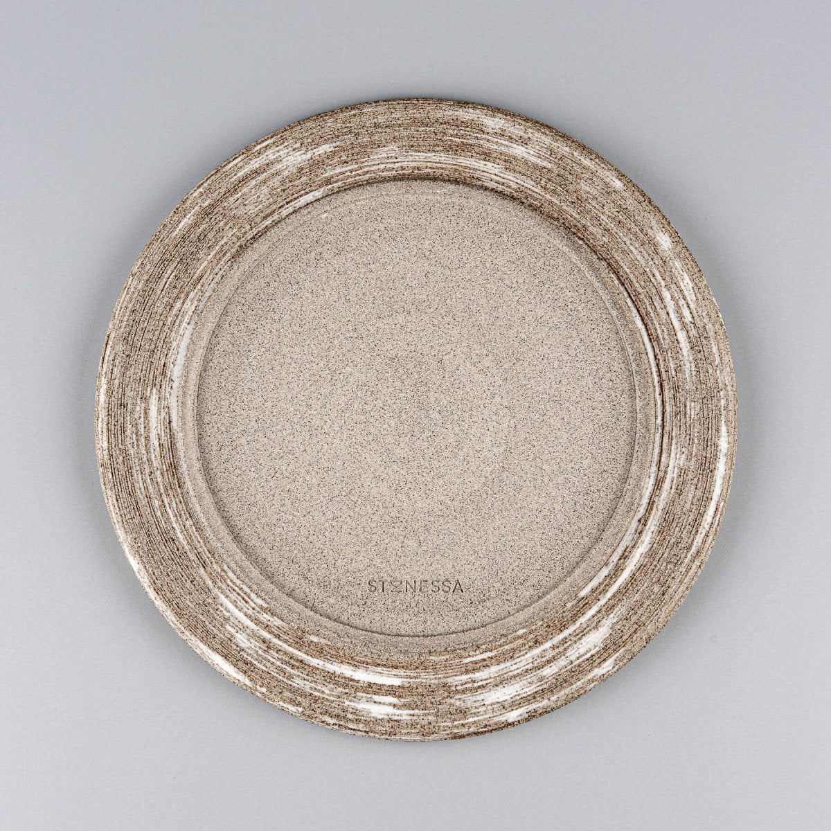 Hand-carved base of handmade ceramic plate showcasing natural clay texture and artisanal craftsmanship.
