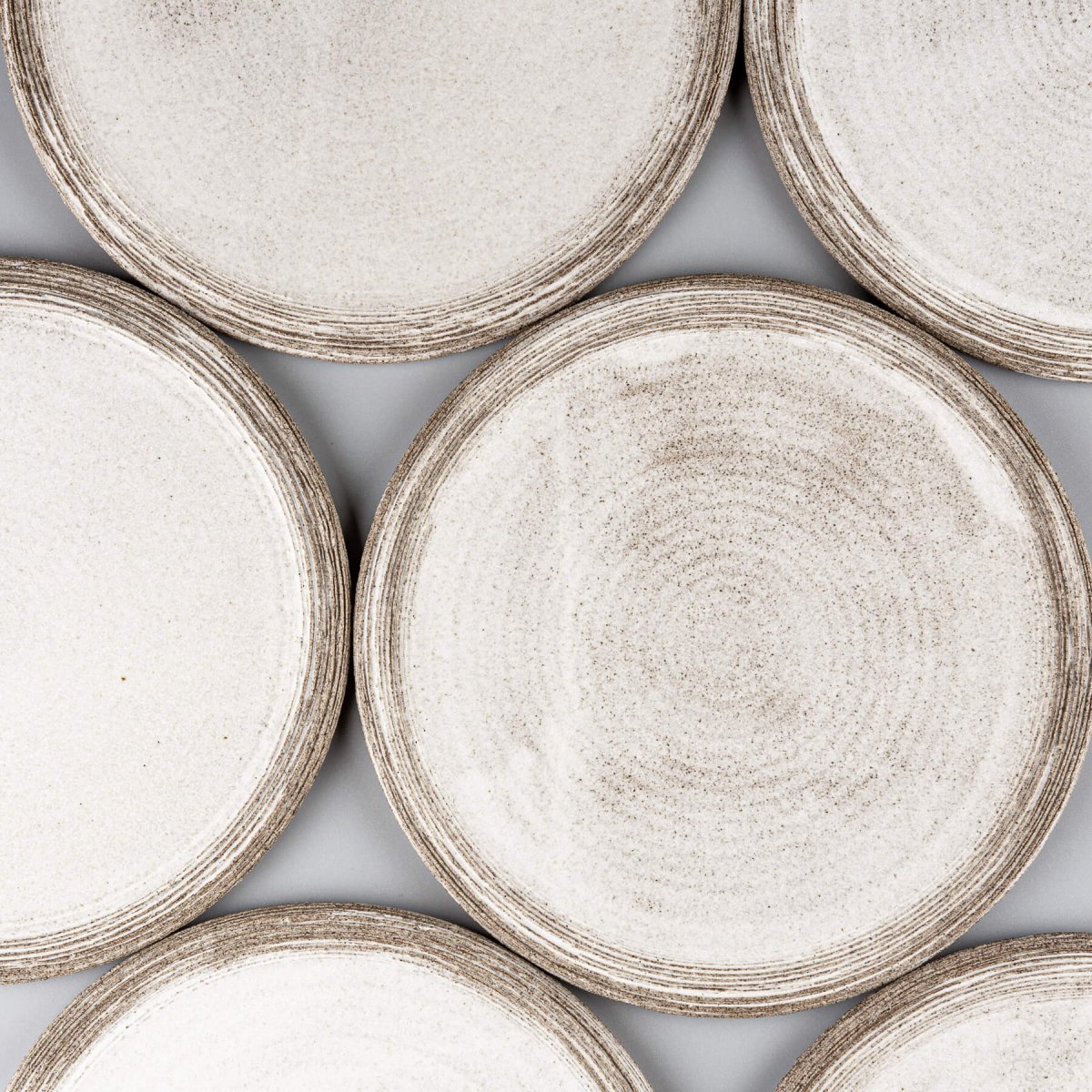 Set of artisanal ceramic plates with minimalist, elegant design for gourmet plating.
