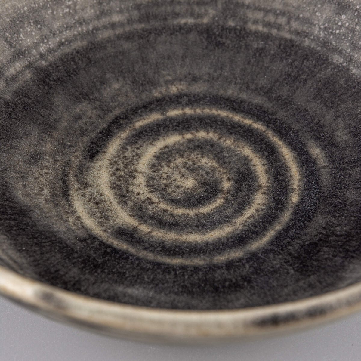 Textured ceramic bowl with matte glaze and natural stoneware feel, suitable for private collectors and interior styling.